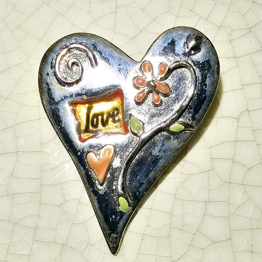 Silver and Orange Heart Sculpture with Romantic Swirls